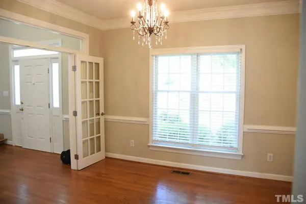 a view of a room with wooden floor and windows