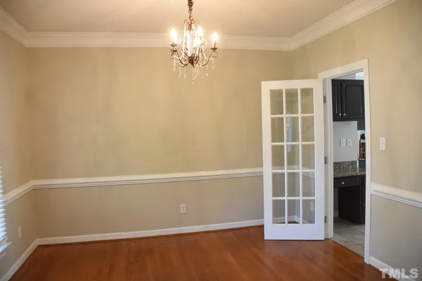an empty room with wooden floor and a window