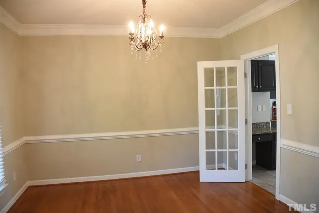 an empty room with wooden floor and a window