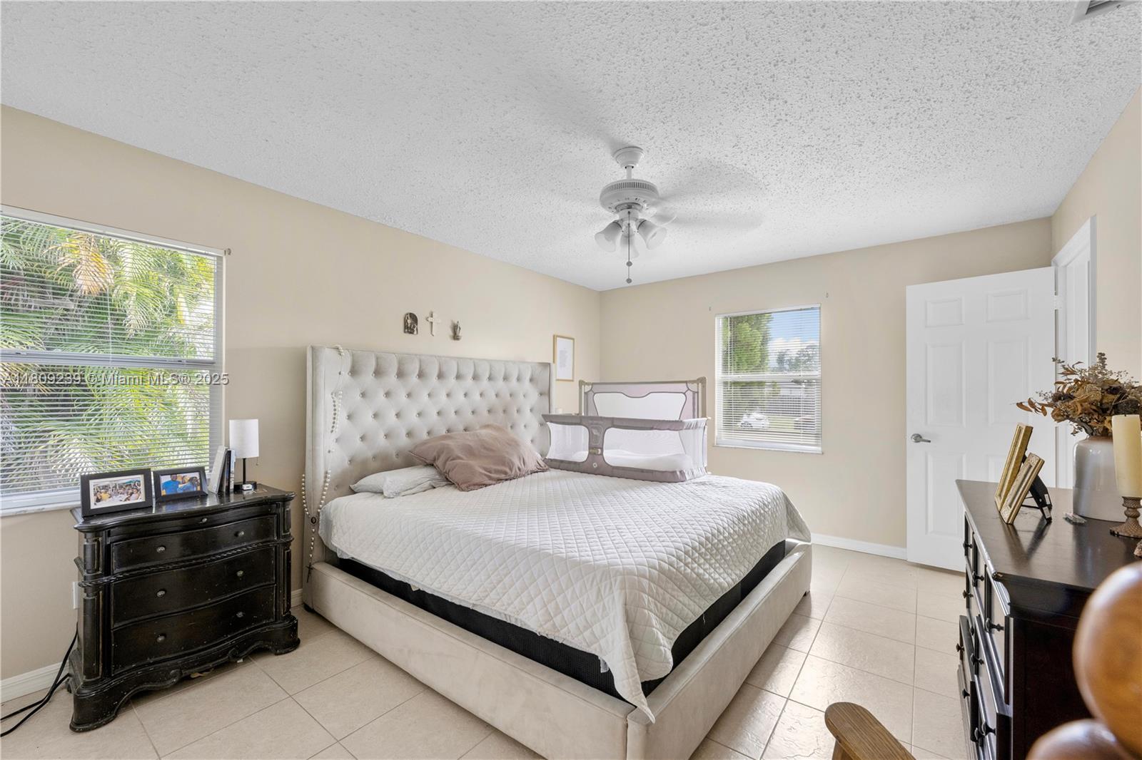 2330 Southwest Lejune Street Port St. Lucie, FL 34953 - Photo 11 of 20 a bedroom with a bed and wooden floor