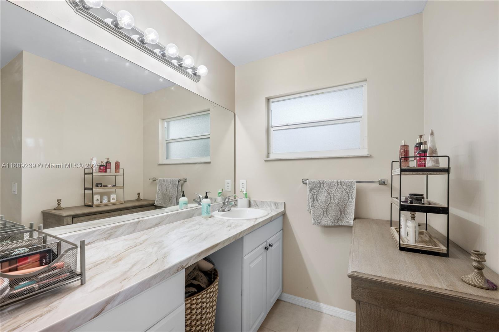 2330 Southwest Lejune Street Port St. Lucie, FL 34953 - Photo 12 of 20 a bathroom with a sink and a mirror