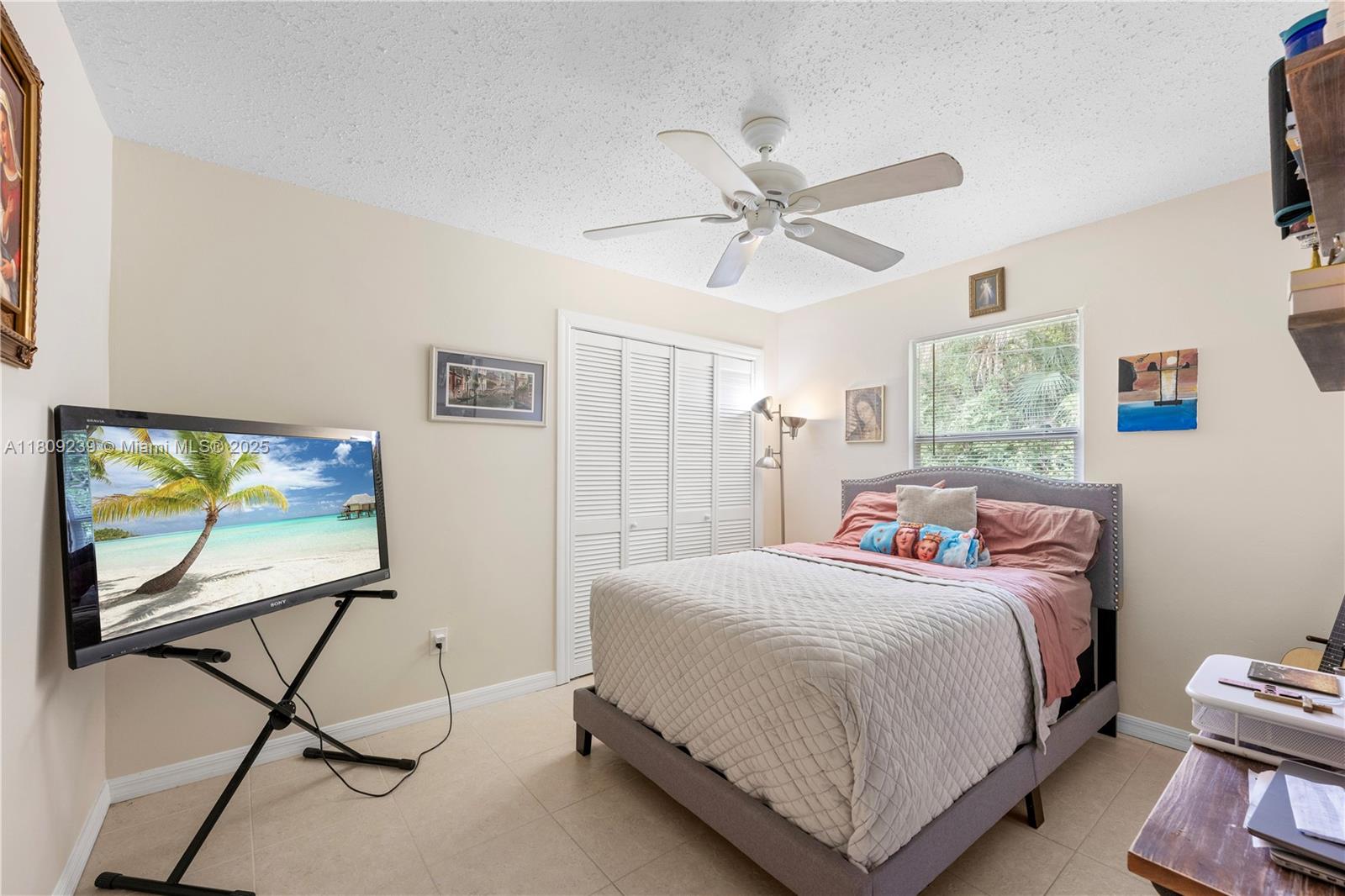 2330 Southwest Lejune Street Port St. Lucie, FL 34953 - Photo 13 of 20 a bedroom with a bed tv and a window