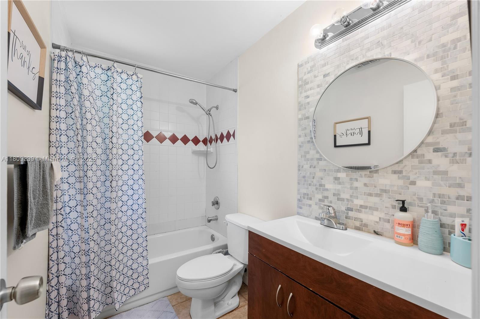 2330 Southwest Lejune Street Port St. Lucie, FL 34953 - Photo 14 of 20 a bathroom with a sink a toilet and a mirror