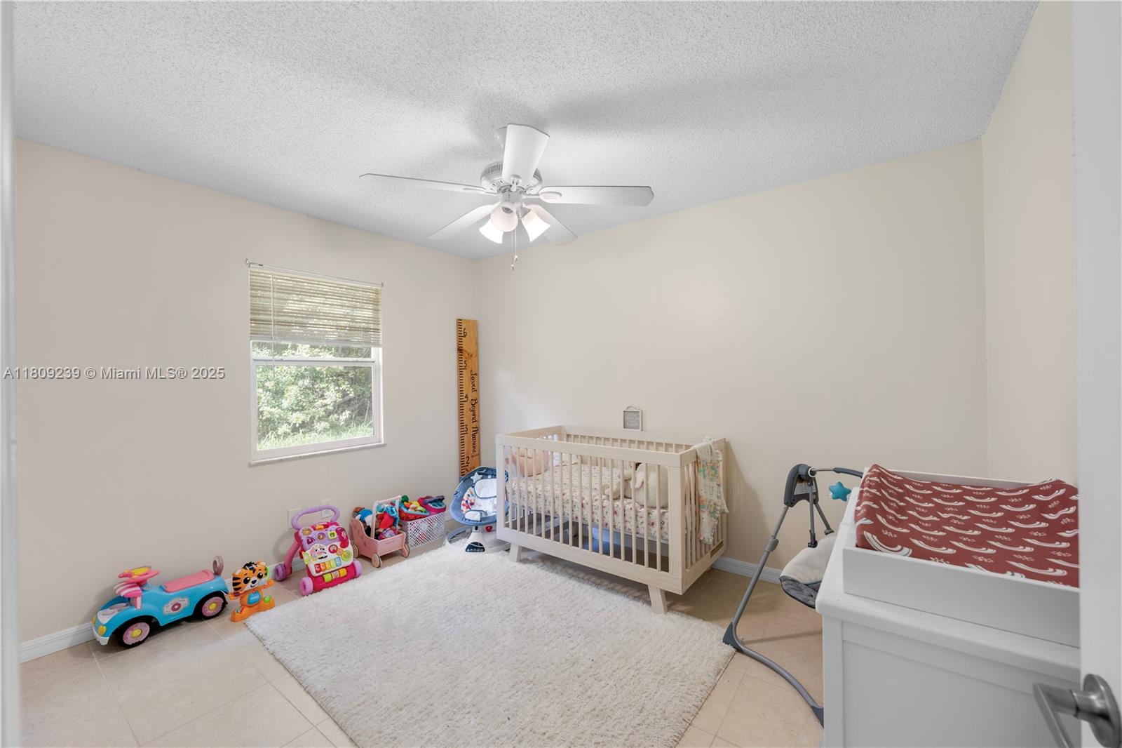 2330 Southwest Lejune Street Port St. Lucie, FL 34953 - Photo 15 of 20 a bedroom with furniture and a chandelier