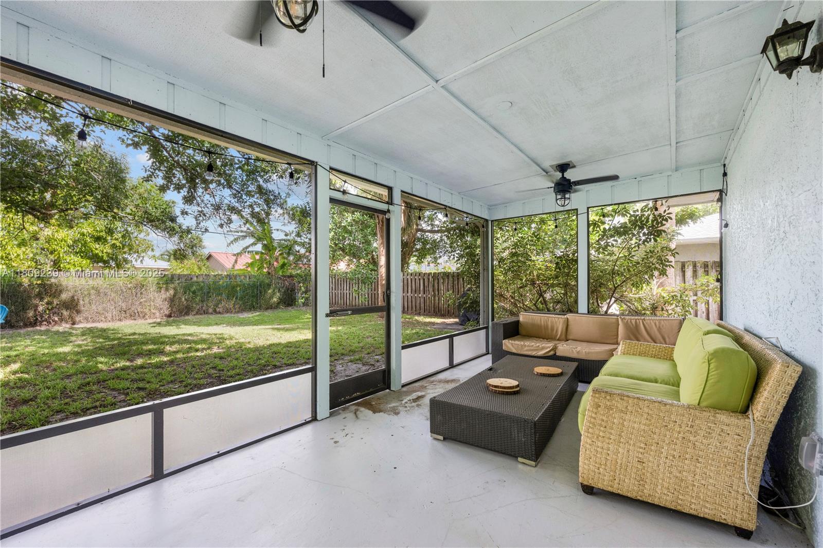 2330 Southwest Lejune Street Port St. Lucie, FL 34953 - Photo 16 of 20 a living room with patio furniture and garden view