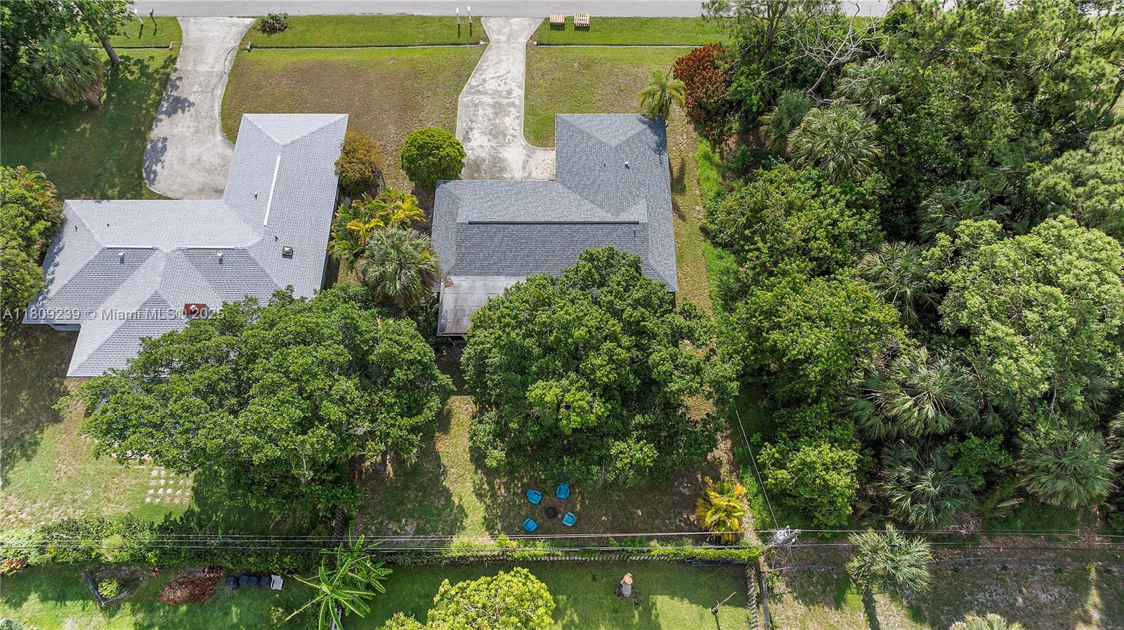 2330 Southwest Lejune Street Port St. Lucie, FL 34953 - Photo 17 of 20 an aerial view of a house with a yard lake and trees all around