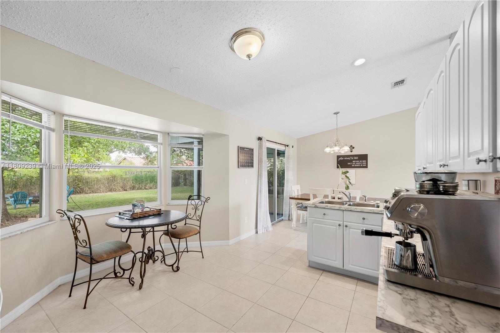 2330 Southwest Lejune Street Port St. Lucie, FL 34953 - Photo 2 of 20 a dining room with furniture and a large window