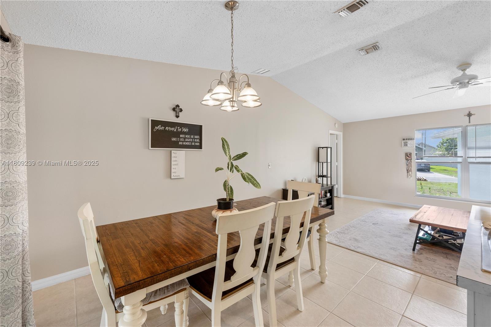 2330 Southwest Lejune Street Port St. Lucie, FL 34953 - Photo 8 of 20 a living room with furniture and a chandelier