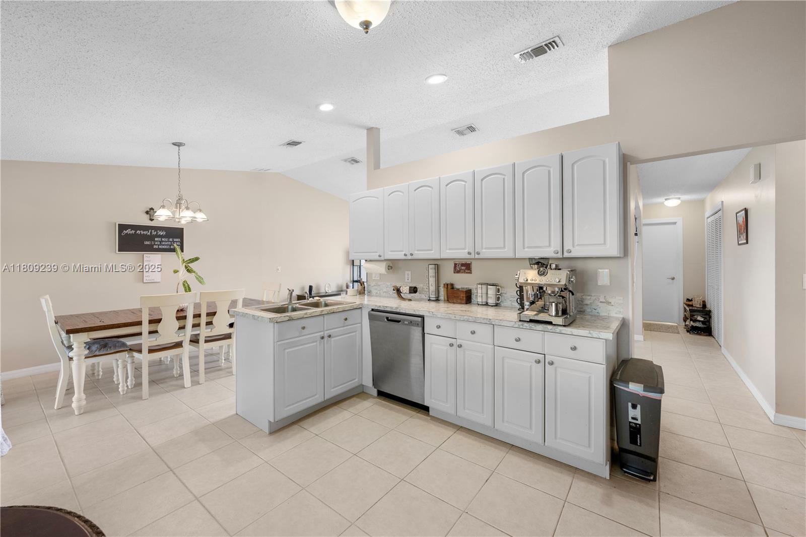 2330 Southwest Lejune Street Port St. Lucie, FL 34953 - Photo 10 of 20 a kitchen with cabinets and chairs