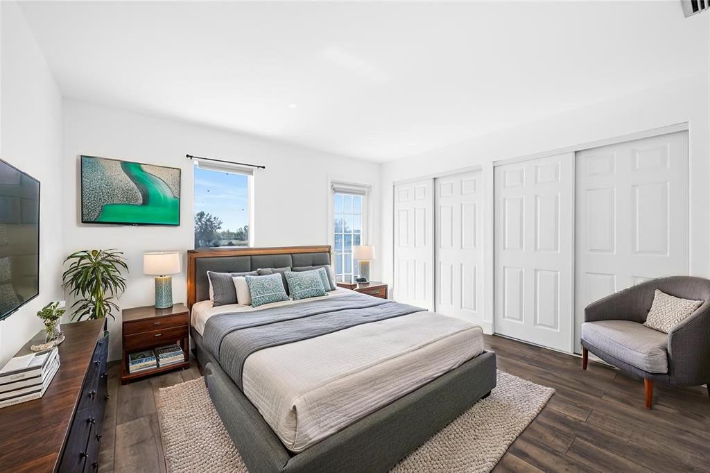 1100 Crystal Lake Drive, Unit 209 Deerfield Beach, FL 33073 - Photo 17 of 34 a bedroom with a bed and a couch