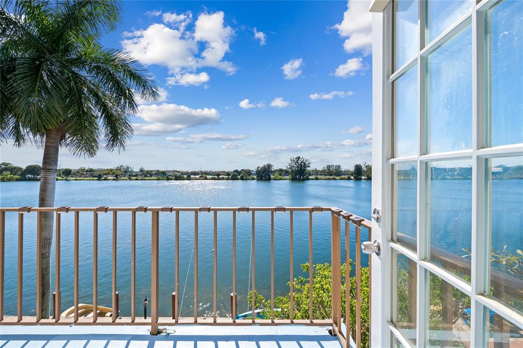 1100 Crystal Lake Drive, Unit 209 Deerfield Beach, FL 33073 - Photo 2 of 34 a view of a balcony with potted plants