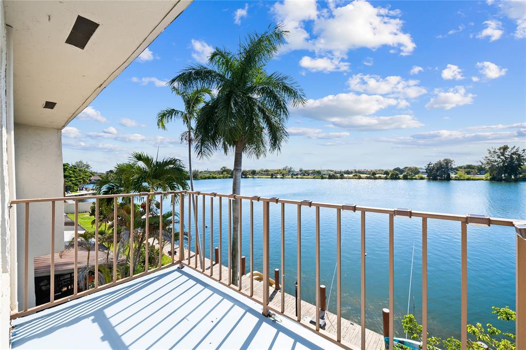 1100 Crystal Lake Drive, Unit 209 Deerfield Beach, FL 33073 - Photo 23 of 34 a view of a balcony with wooden floor