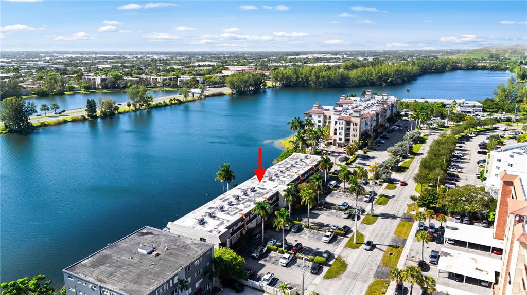 1100 Crystal Lake Drive, Unit 209 Deerfield Beach, FL 33073 - Photo 30 of 34 an aerial view of a city with lawn chairs
