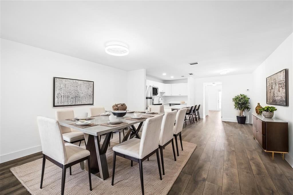 1100 Crystal Lake Drive, Unit 209 Deerfield Beach, FL 33073 - Photo 3 of 34 a view of a dining room with furniture and wooden floor