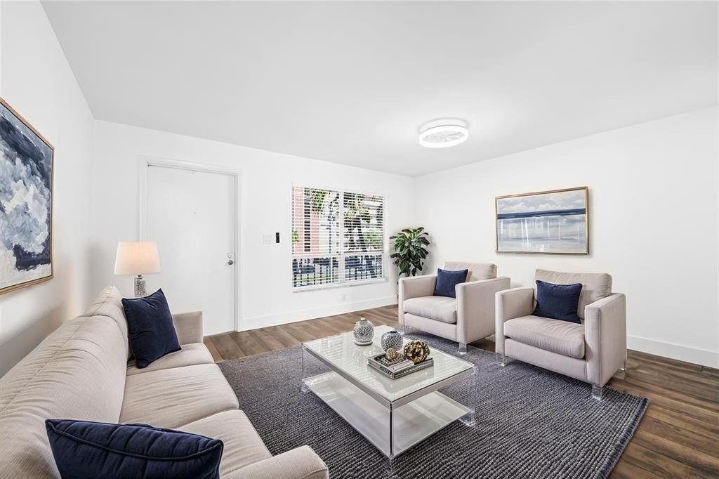 1100 Crystal Lake Drive, Unit 209 Deerfield Beach, FL 33073 - Photo 5 of 34 a living room with furniture rug and window