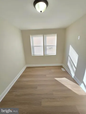 a view of room with window and hardwood floor