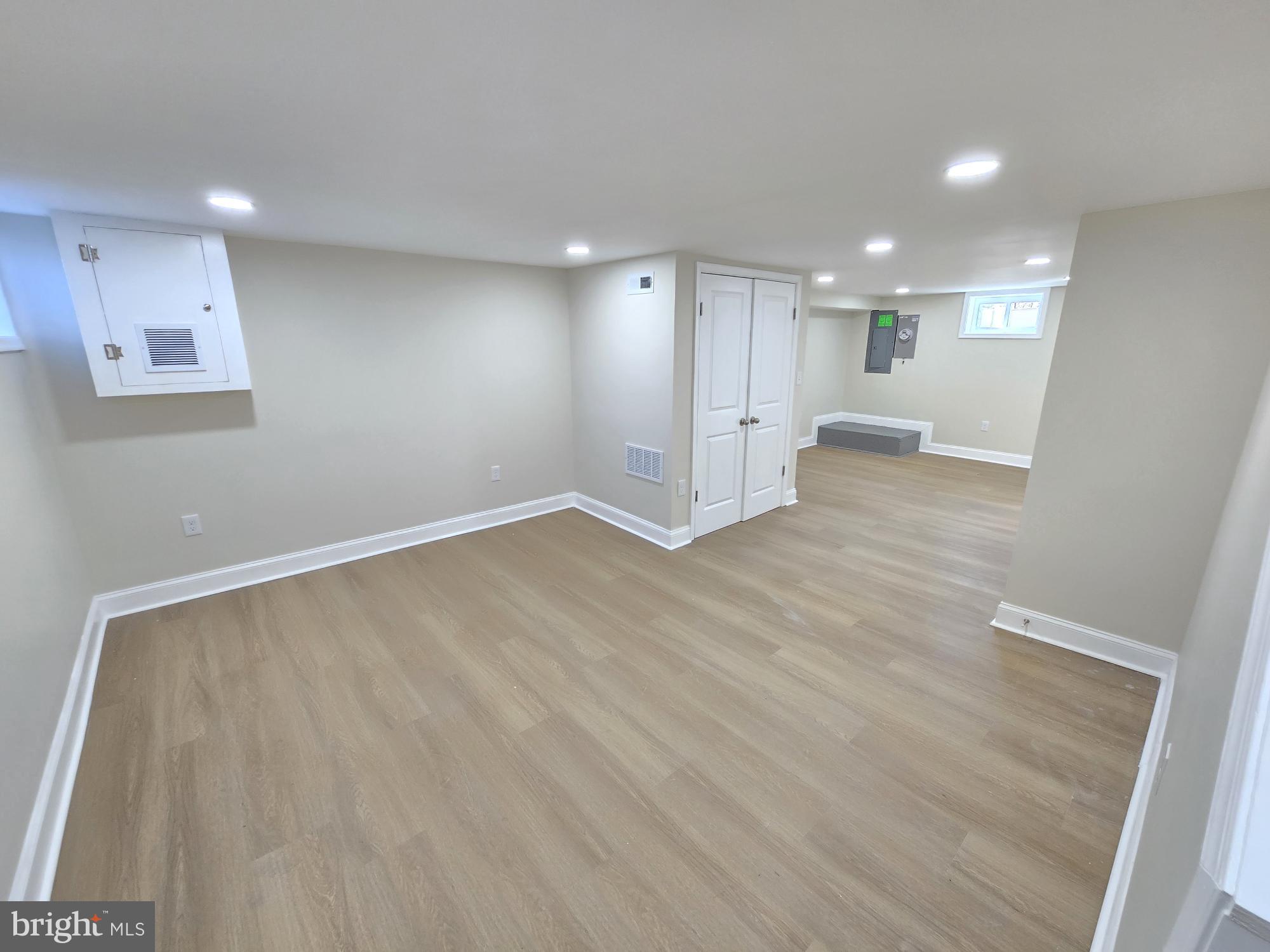 3838 Greenspring Avenue Baltimore, MD 21211 - Photo 20 of 23 an empty room with wooden floor and windows