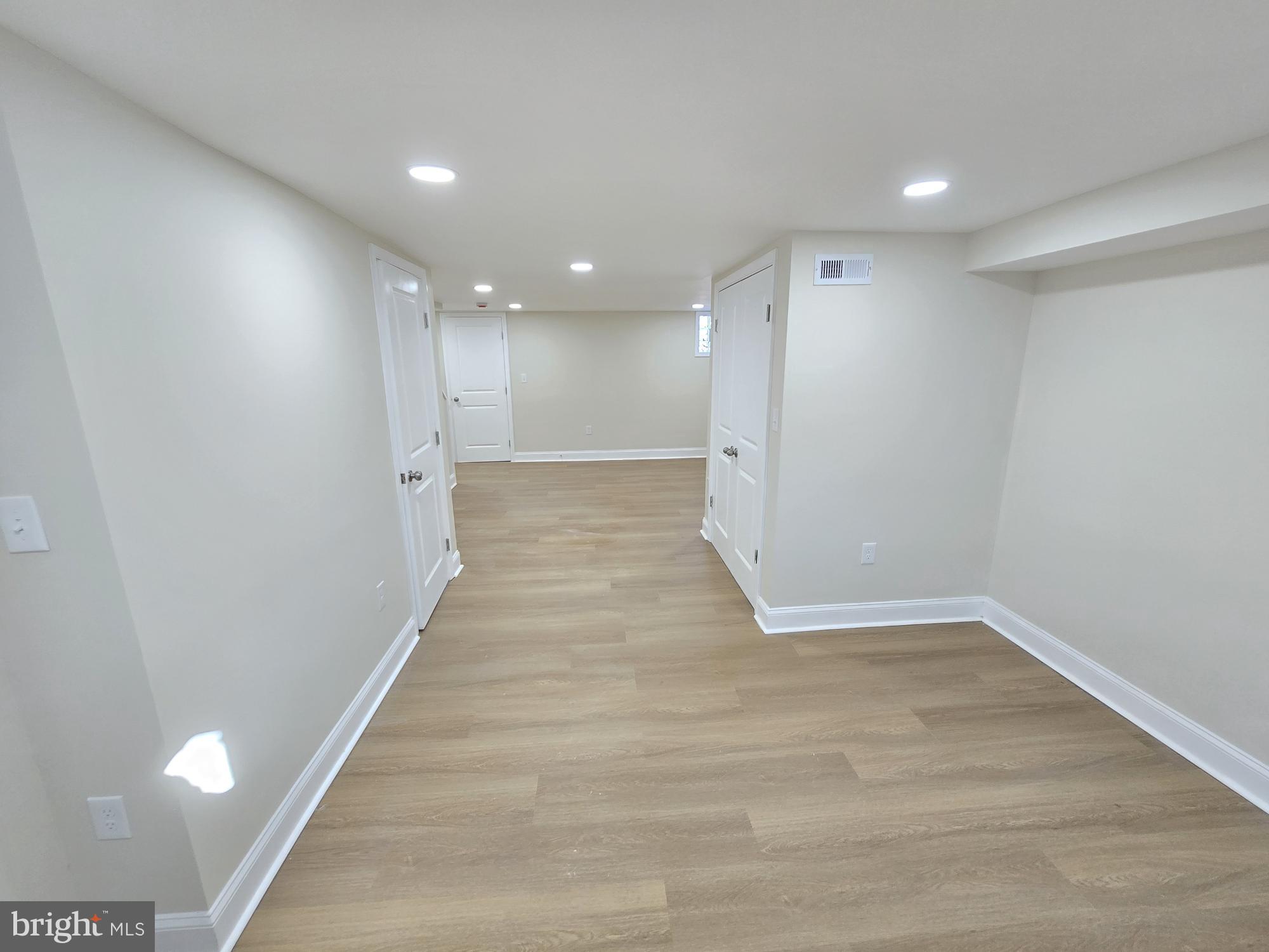 3838 Greenspring Avenue Baltimore, MD 21211 - Photo 21 of 23 a view of an empty room with wooden floor