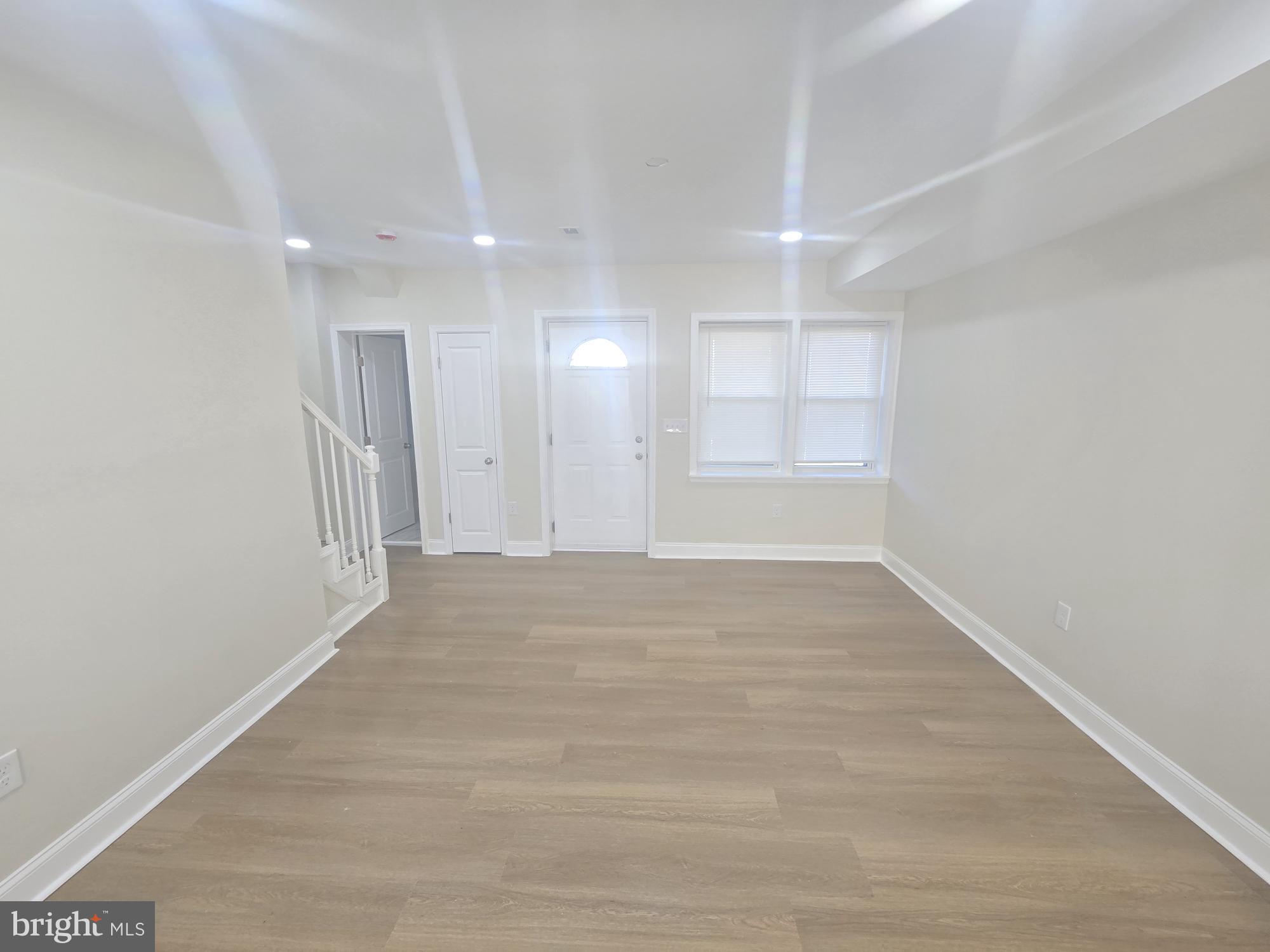 3838 Greenspring Avenue Baltimore, MD 21211 - Photo 4 of 23 a view of empty room with wooden floor and fan