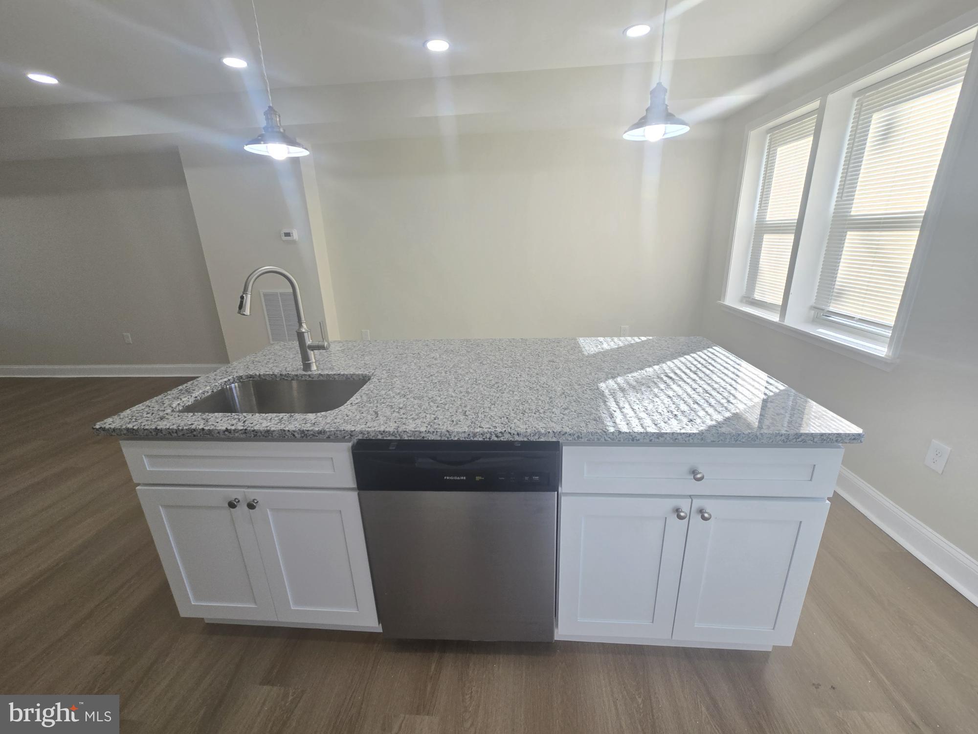 3838 Greenspring Avenue Baltimore, MD 21211 - Photo 5 of 23 a kitchen with a sink and wooden floor