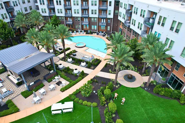 a swimming pool with outdoor seating and yard