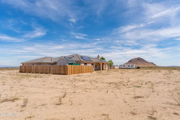 a view of wooden house with a yard