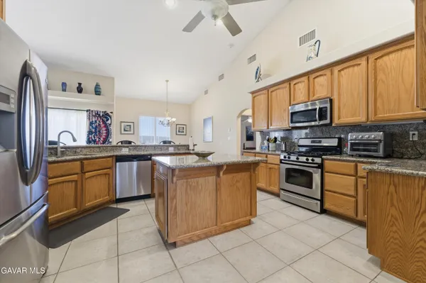 a kitchen with stainless steel appliances granite countertop a sink and cabinets