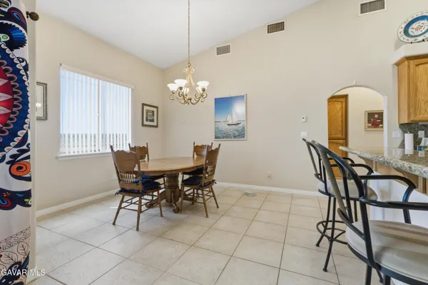 a view of a dining room with furniture and chandelier