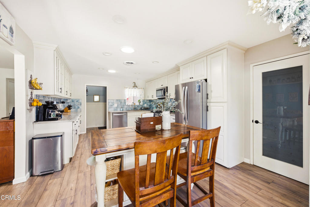 616 Island View Street Fillmore, CA 93015 - Photo 11 of 57 a kitchen with stainless steel appliances a refrigerator a stove top oven a refrigerator and island with wooden floor