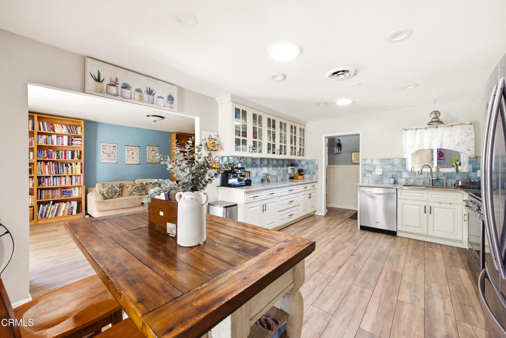 616 Island View Street Fillmore, CA 93015 - Photo 12 of 57 a kitchen with stainless steel appliances granite countertop a stove and white cabinets