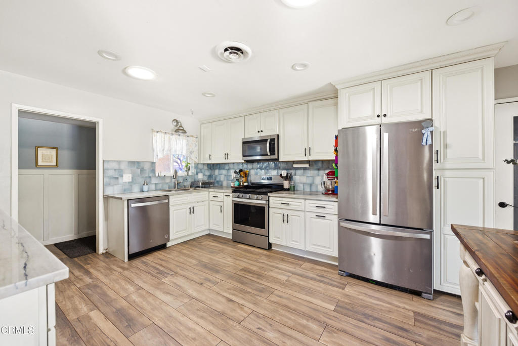 616 Island View Street Fillmore, CA 93015 - Photo 7 of 57 a kitchen with a refrigerator stove and wooden cabinets