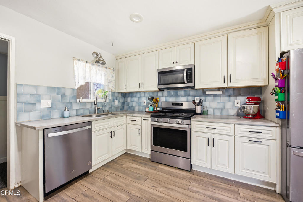 616 Island View Street Fillmore, CA 93015 - Photo 10 of 57 a kitchen with kitchen island granite countertop a sink cabinets and stainless steel appliances