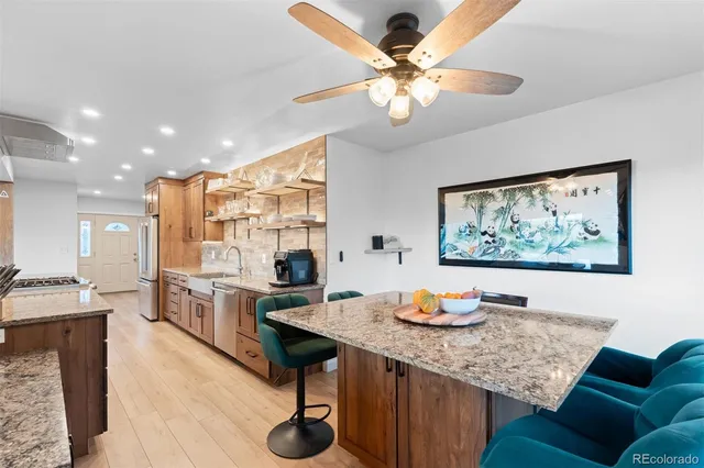 a view of kitchen island with stainless steel appliances refrigerator dining table and chairs