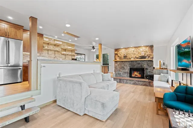 a living room with furniture a flat screen tv and a fireplace