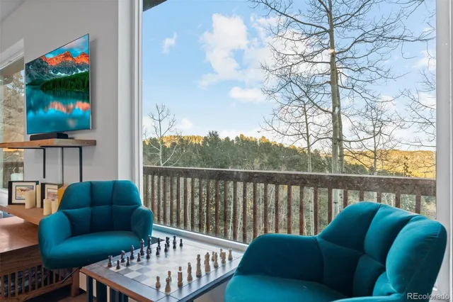 a balcony with furniture and a potted plant