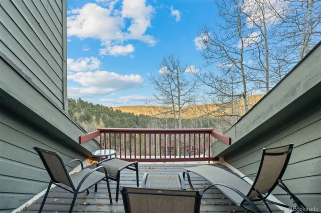 a view of a chairs and table in the balcony