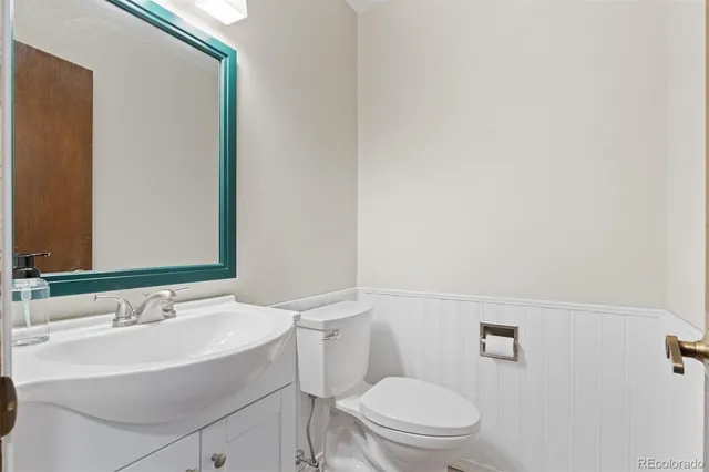 a bathroom with a sink a toilet and a mirror