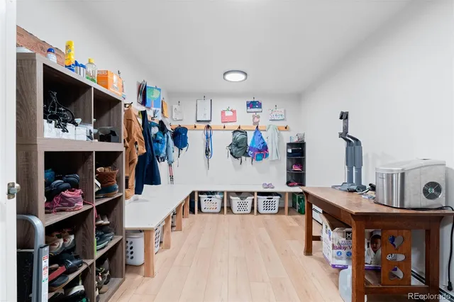 a view of walk in closet with clothes and shoes