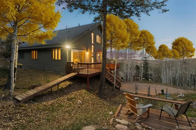 a backyard of a house with barbeque oven table and chairs