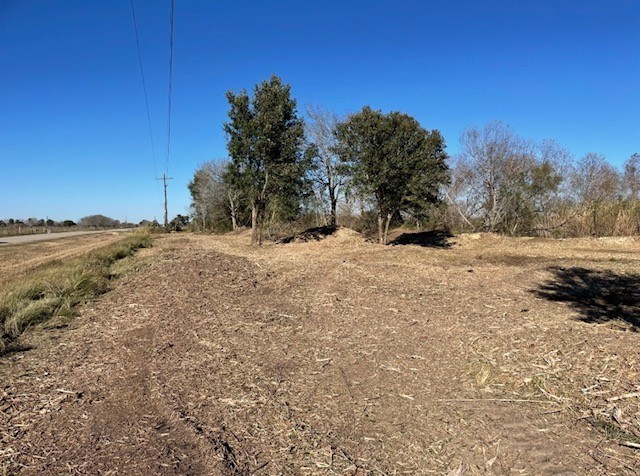 22099 Sattler Road Winnie, TX 77665 - Photo 15 of 20 a view of a yard covered with snow in the background