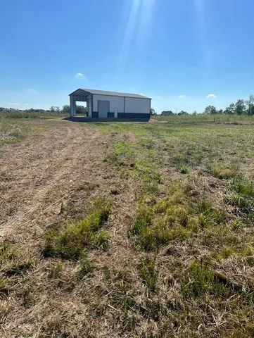 a view of a field with an ocean