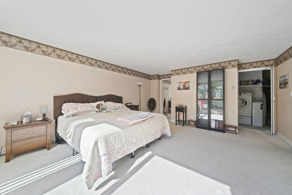 9 Broadway, Unit 305 Saugus, MA 01906 - Photo 14 of 32 a spacious bedroom with a bed and a window