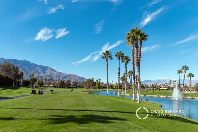 a view of a golf course with a lake view