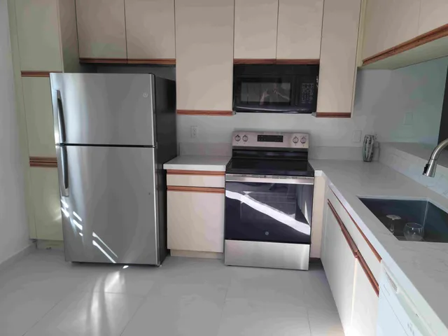 a kitchen with a refrigerator stove and sink