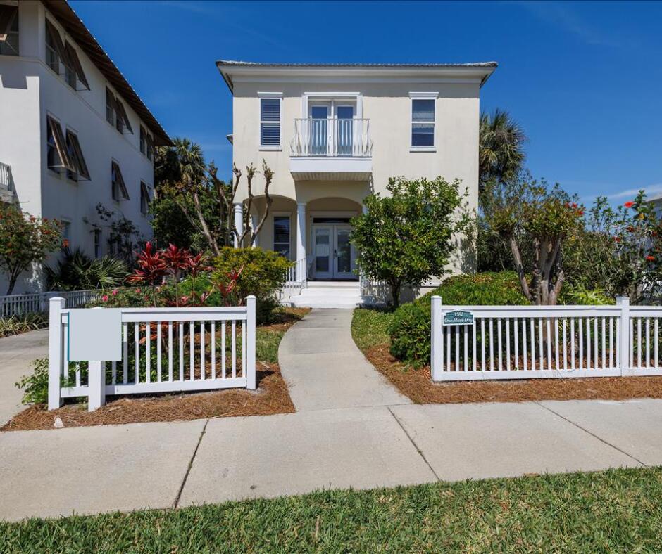 a view of a house with porch and wooden bench
