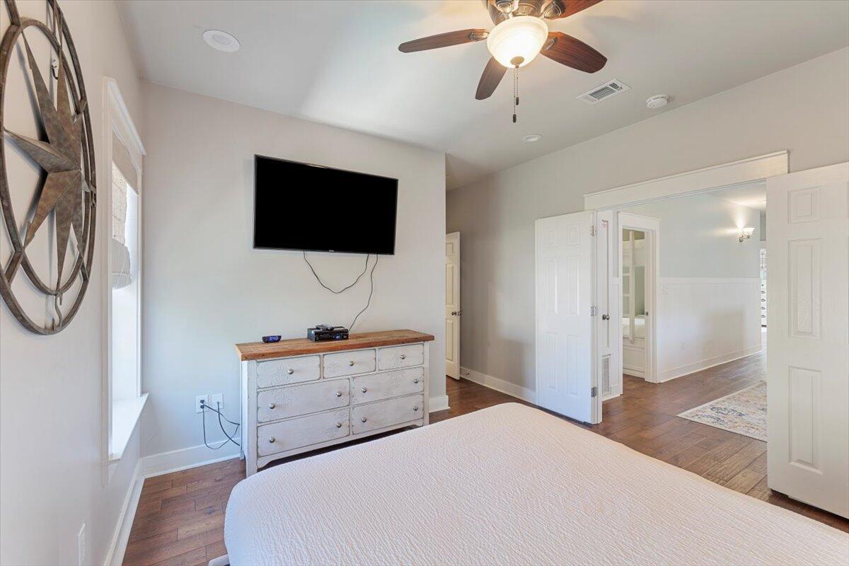 3581 Waverly Circle Destin, FL 32541 - Photo 16 of 33 a bedroom with a bed a flat screen tv and a chandelier