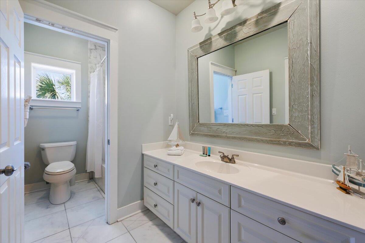 3581 Waverly Circle Destin, FL 32541 - Photo 17 of 33 a bathroom with a sink a toilet and a mirror