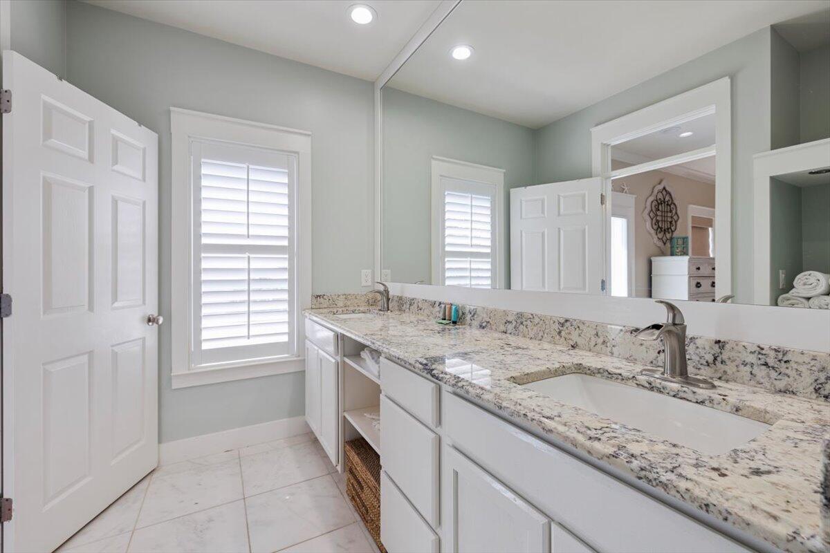 3581 Waverly Circle Destin, FL 32541 - Photo 26 of 33 a bathroom with a granite countertop sink and a mirror