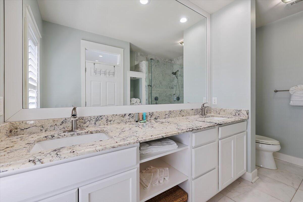 3581 Waverly Circle Destin, FL 32541 - Photo 27 of 33 a bathroom with a granite countertop sink a toilet and a mirror