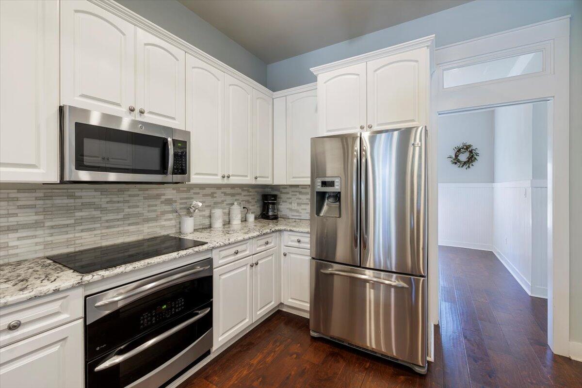 3581 Waverly Circle Destin, FL 32541 - Photo 10 of 33 a kitchen with stainless steel appliances a white cabinets and a wooden floor